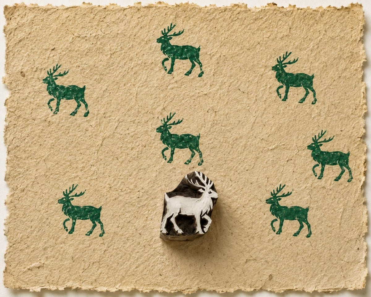 Hand carved Highland Deer wooden block stamp with forest green deer impressions on handmade natural fibre paper.