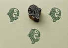 Hand carved twin fish print block creating green folk art impressions on handmade paper.