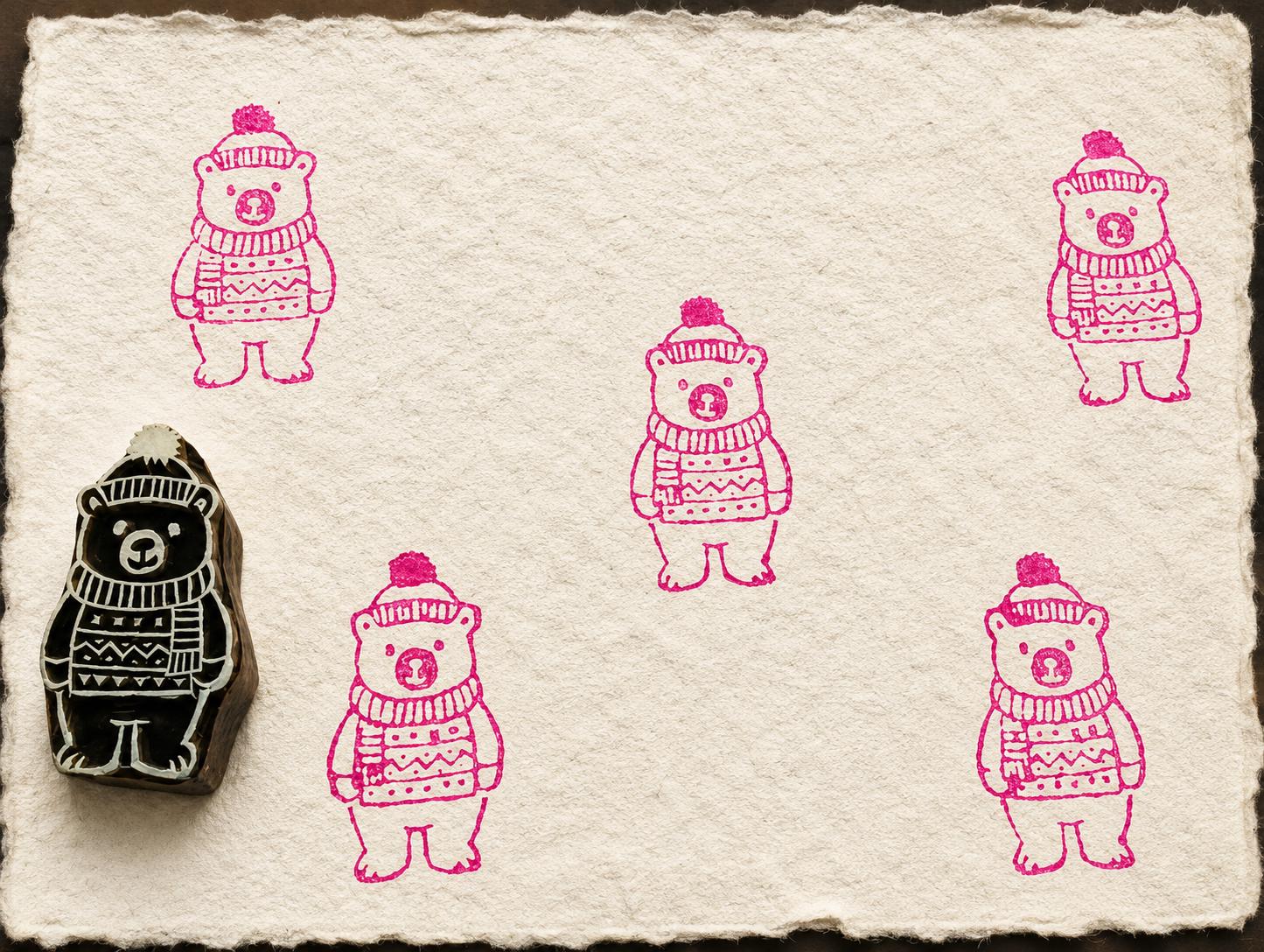 Bear wooden printing block with repeated winter bear impressions on handmade paper
