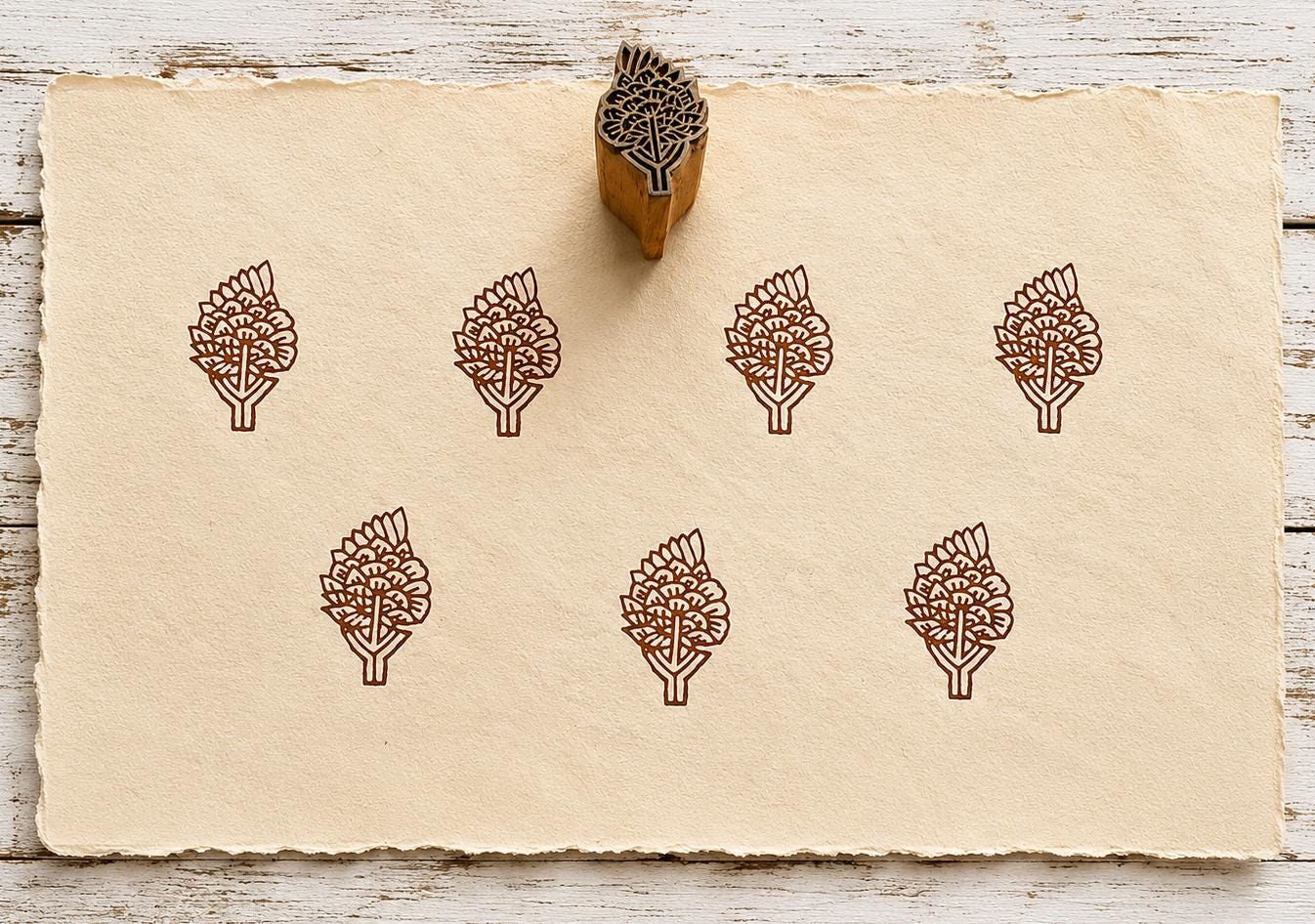 Hand carved Blooming Branch wooden block stamp with repeating brown botanical impressions on handmade paper.