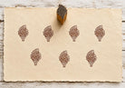 Hand carved Blooming Branch wooden block stamp with repeating brown botanical impressions on handmade paper.