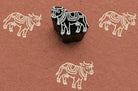 Hand carved Ceremonial Cow wooden block stamp with ivory impressions on terracotta handmade paper.