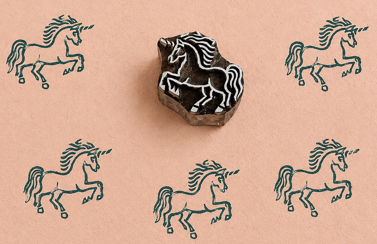 Hand carved Indian wooden printing block featuring a Nordic-style unicorn in a rearing pose, stamped in teal ink on handmade blush paper, suitable for fabric printing, pottery decoration, clay impressions, and paper crafts.