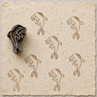 Hand carved Playful Dolphin wooden printing block with stylized dolphin print on handmade paper.