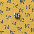 Hand carved Flutter Butterfly wooden printing block with decorative butterfly print on handmade yellow paper.