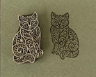 Hand carved Ornate Cat wooden printing block with detailed black cat impression on sage green handmade paper.