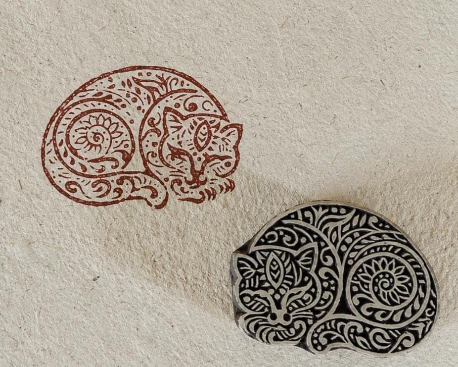 Hand-carved paisley cat wooden printing block with an intricate feline impression on handmade paper, perfect for fabric printing, paper crafts, journaling, and textile art.