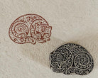 Hand-carved paisley cat wooden printing block with an intricate feline impression on handmade paper, perfect for fabric printing, paper crafts, journaling, and textile art.