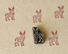 Hand-carved wooden floral deer printing block with repeated burgundy deer impressions on handmade paper.