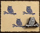 Hand-carved Branch Perched Owl wooden printing block with blue owl impressions on textured handmade paper.