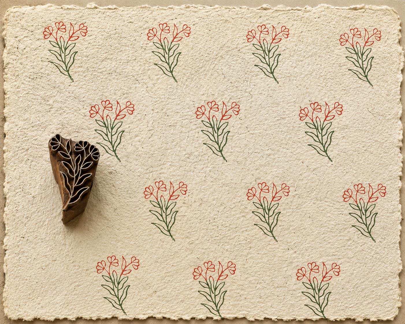 Hand carved Heart Bloom wooden printing block with delicate heart-shaped floral stem printed on handmade paper in earthy red and green ink.