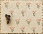 Hand carved Heart Bloom wooden printing block with delicate heart-shaped floral stem printed on handmade paper in earthy red and green ink.