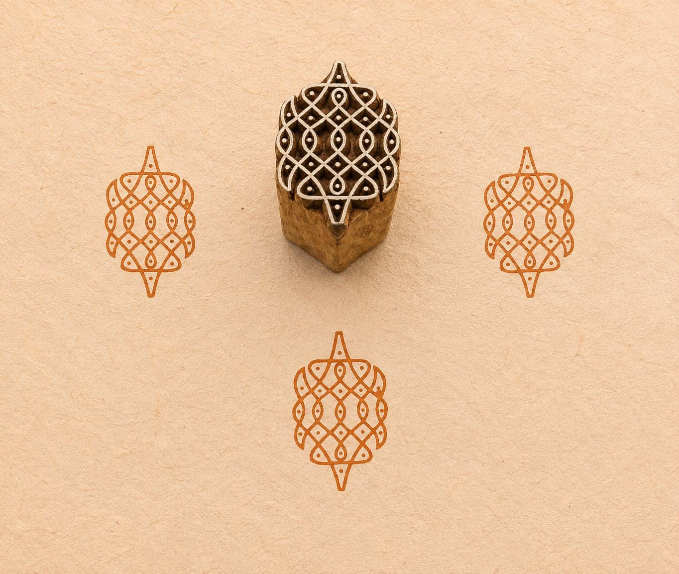 Hand carved Geometric Rangoli wood block stamp with green block print impressions on handmade paper, traditional Indian printing block for fabric, pottery, clay and paper crafts.