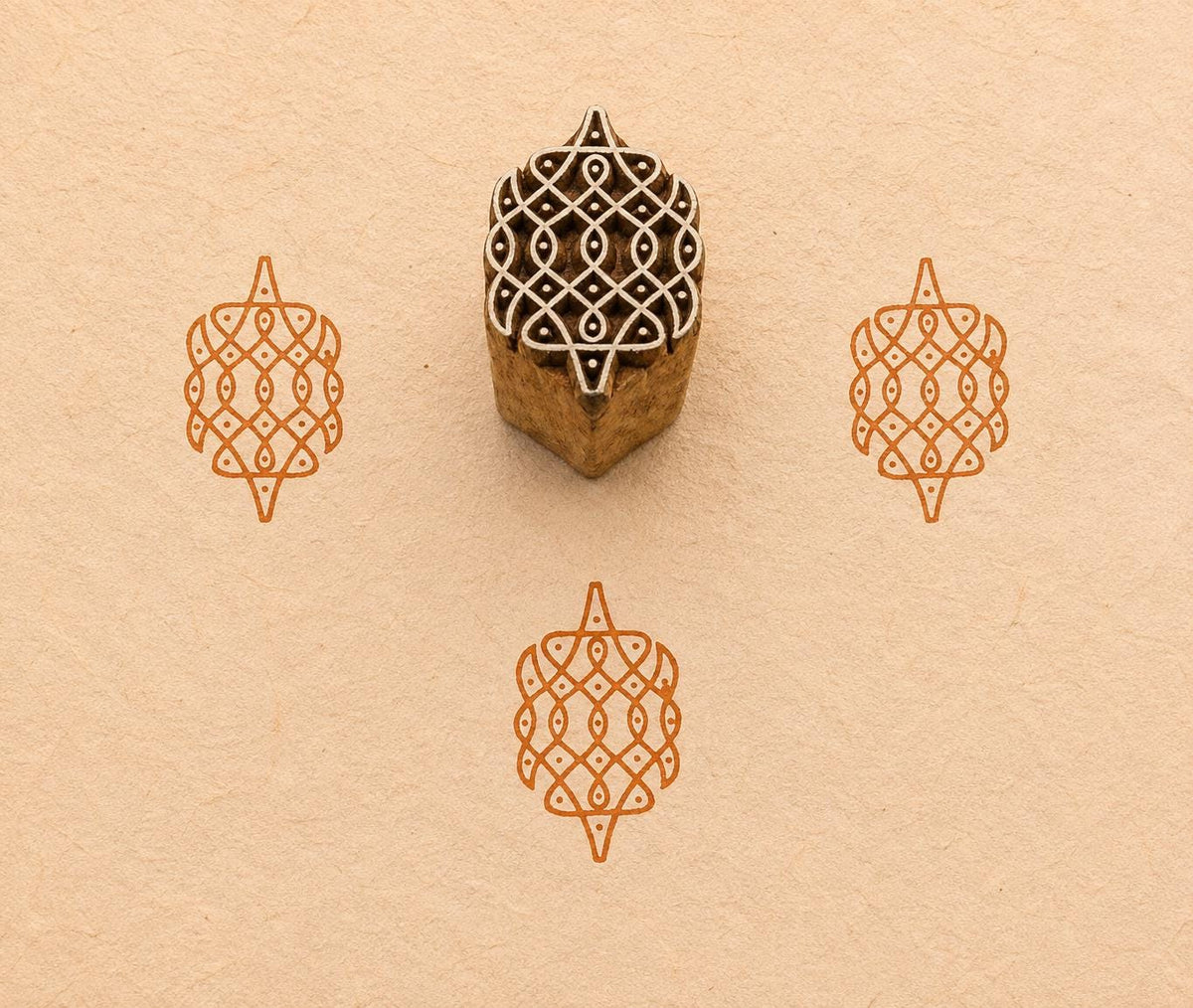 Hand carved Geometric Rangoli wood block stamp with green block print impressions on handmade paper, traditional Indian printing block for fabric, pottery, clay and paper crafts.