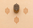 Hand carved Geometric Rangoli wood block stamp with green block print impressions on handmade paper, traditional Indian printing block for fabric, pottery, clay and paper crafts.