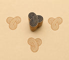 Hand carved Infinity Knot wooden printing block with interlocking geometric pattern printed on handmade paper for fabric printing, textile design, pottery, clay and paper crafts.