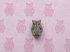 Hand-carved Hoot Owl wooden printing block with detailed owl impressions on textured pink handmade paper.