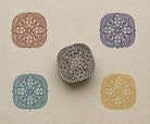 Hand carved wooden block printing symmetrical four petal mandala pattern in various colours