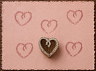 Hand carved Stitched Heart wood block stamp with a decorative stitched heart print on pink handmade paper for fabric printing, pottery, clay and paper crafts.