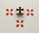 Hand carved Indian wooden fabric printing block featuring a minimalist four-petal geometric design with printed impressions on handmade paper.