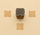 Hand carved Indian wooden textile printing block featuring a Temple Diamonds geometric pattern with nested diamonds, stamped in ochre on handmade paper.