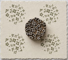 Hand carved Indian wooden printing block with a scattered folk motif of small floral and geometric shapes, shown printed on handmade paper.