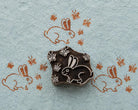 Hand-carved rabbit woodblock with butterfly motifs printed on handmade blue paper