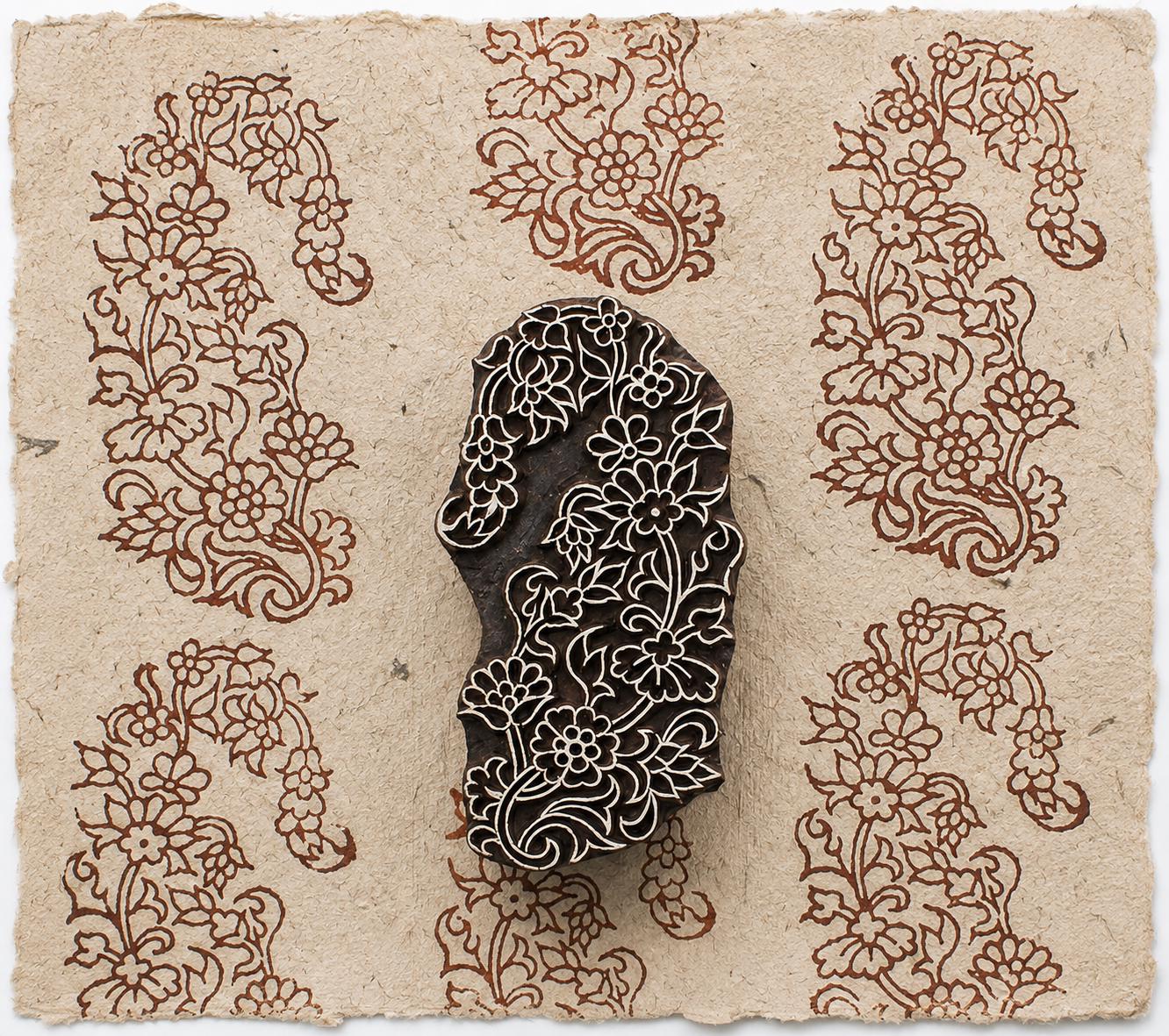Hand carved Indian Garden Paisley wood stamp with an ornate floral paisley impression on handmade paper.
