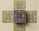 Hand carved Indian wood printing block with a four-way petal and diamond motif, shown creating a repeating pattern on handmade paper