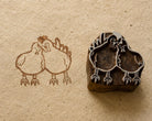 Hand carved Romantic Roosters wooden printing block showing two roosters facing each other in a folk art style