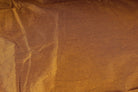 Close-up of burnt caramel poly dupioni fabric showing its fine slubbed texture and warm golden brown colour.