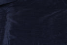 Midnight navy polyester dupioni fabric gathered in the centre, showing its elegant drape and subtle textured finish.