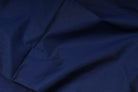Royal blue faux dupioni fabric draped in soft folds to show its texture and sheen