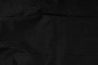 Draped jet black faux dupioni fabric showing its folds, texture and subtle sheen.