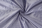 Close-up of smoky lavender faux dupioni fabric arranged in soft folds, showing its textured faux silk finish.