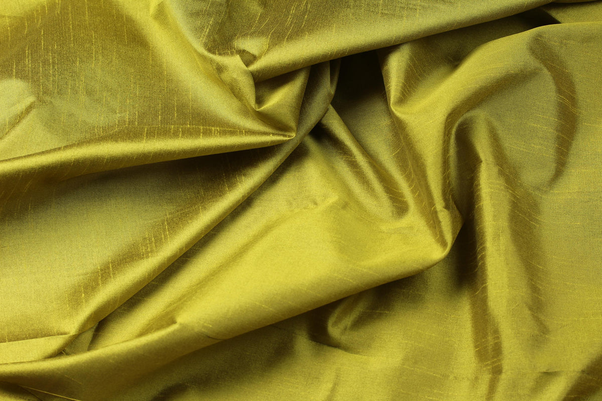 Golden olive faux silk fabric draped in soft folds, showing its sheen and fluid appearance.