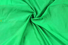 Close-up of parrot green faux silk fabric showing its smooth texture and natural drape
