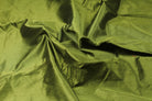 Olive green faux dupioni silk fabric arranged in folds to show its subtle sheen and textured surface.