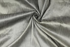 Silver grey faux silk dupioni fabric draped to show its soft sheen and texture.