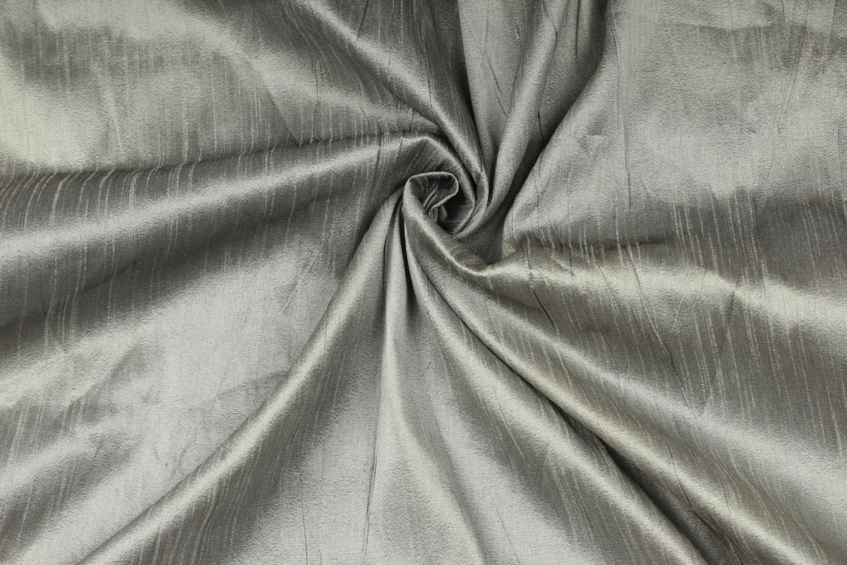 Silver grey faux silk dupioni fabric draped to show its soft sheen and texture.
