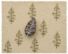 Evergreen tree printing block with repeated tree impressions on handmade paper