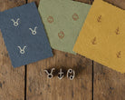 Tiny wooden zodiac printing block set featuring Taurus, Cancer and Sagittarius symbols
