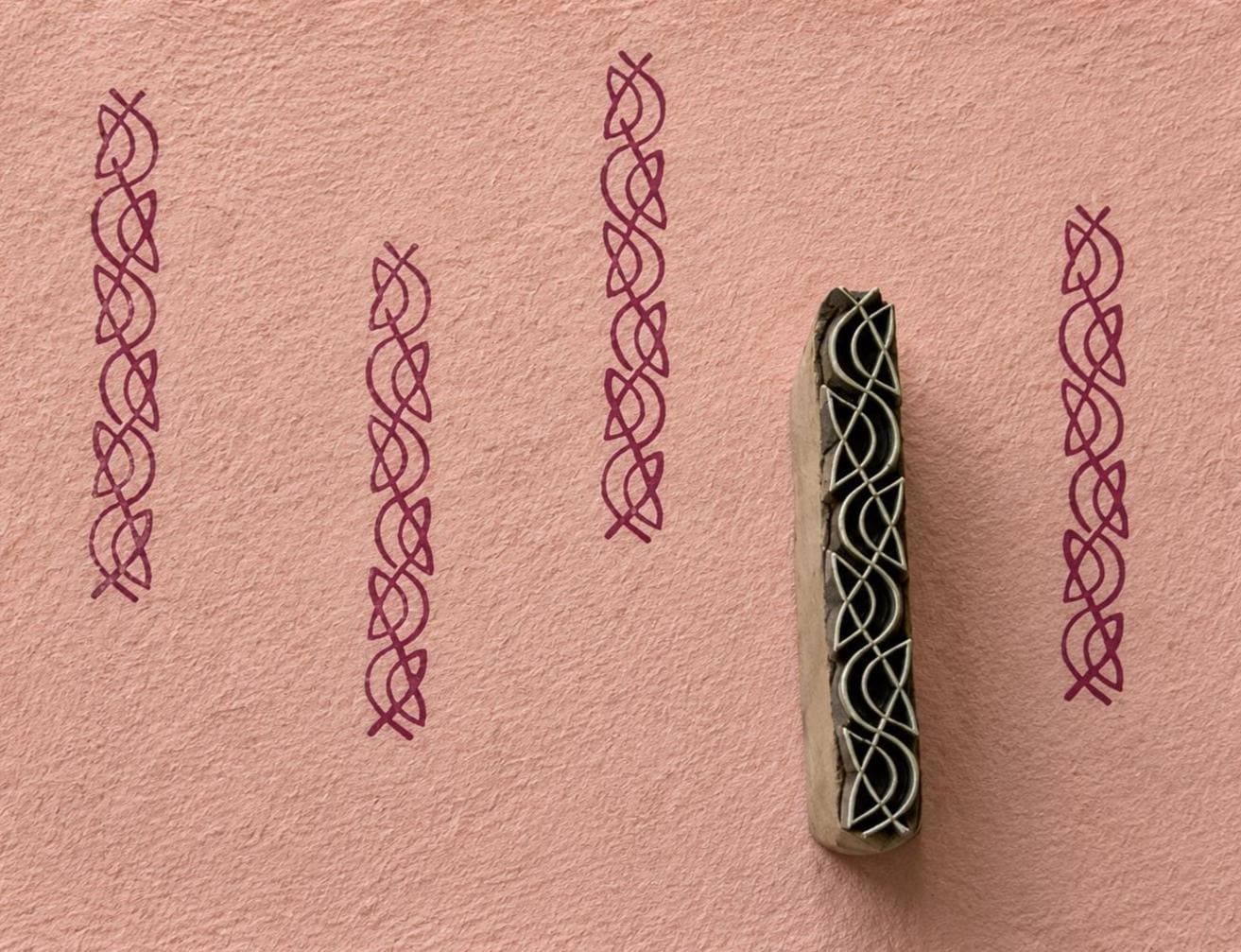 Interlaced knot border printing block with repeated impressions on handmade paper