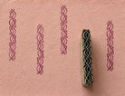 Interlaced knot border printing block with repeated impressions on handmade paper