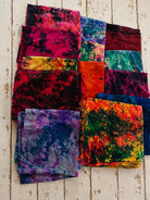 Assorted recycled sari silk fabric pieces in bright tie-dyed colours and patterns