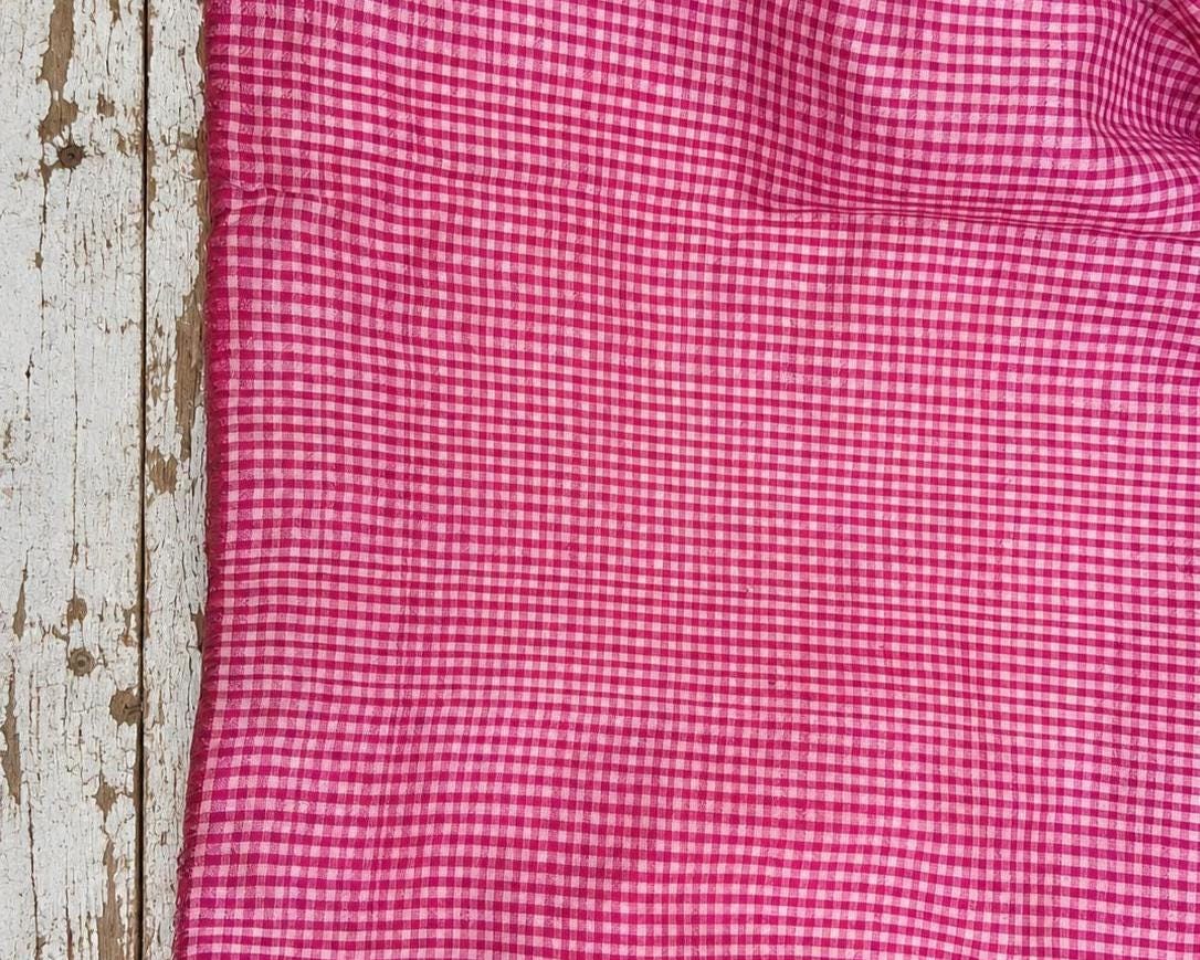 Folded vintage pink and white checked pure silk saree fabric piece with finished edges