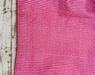 Folded vintage pink and white checked pure silk saree fabric piece with finished edges