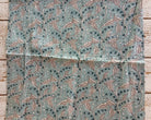 Aqua blue mulmul cotton showing the repeating Indian trailing leaf and botanical print