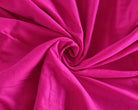 Fuchsia silk sari fabric loosely draped to show its soft flowing quality and subtle sheen