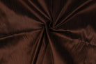 Chocolate brown textured faux silk fabric arranged in folds to display its dupioni look